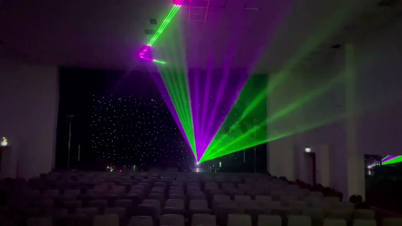 Лазерное шоу — зелёные и фиолетовые лучи в зале со звёздным LED-фоном